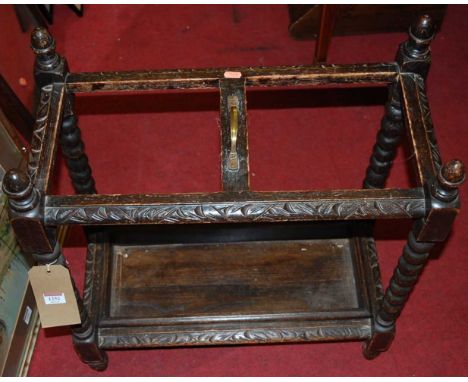 An early 20th century relief carved oak bobbin turned twin division stick-stand, w.58.5cm