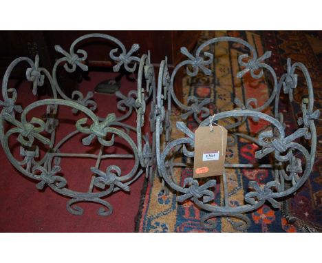 A pair of wrought metal floral design planter frames, width 31cm