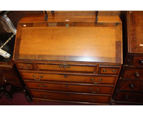 A Geoge III oak bureau on bracket feet, 98cm