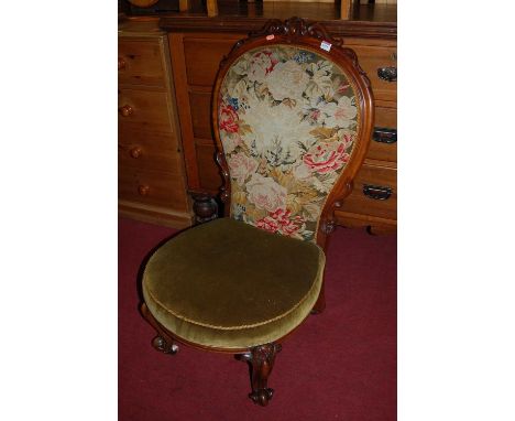 A mid-Victorian carved mahogany show frame and floral tapestry needlework upholstered parlour chair