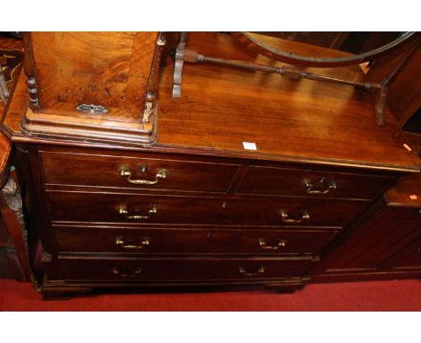 A George III mahogany chest of two short over three long graduated drawers, flanked by reeded pilasters on ogee bracket feet,