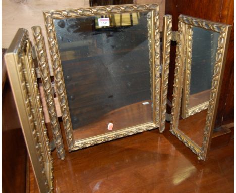 A gilt framed triptych dressing table mirror