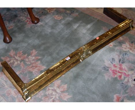 A late Victorian brass kerb fender, having floral decorated mounts, w.120cm 