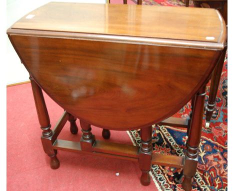 A mahogany drop leaf occasional table, having a gate leg action