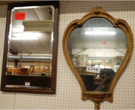 A 19th century mahogany cushion moulded and bevelled rectangular wall mirror; together with a floral carved shaped wall mirro