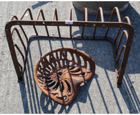 A cast iron wall mounted hay feeder and a Haseley tractor seat. Hay feeder, H54cm x W67ccm x D43cmAll items in this auction a