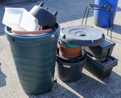 A selection of various pots and a water butt. The pots including plastic and ceramic examples of various sizes, the water but