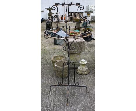 A wrought iron free standing three tier candelabra. H146cmAll items in this auction are sold as seen, We are unable to provid