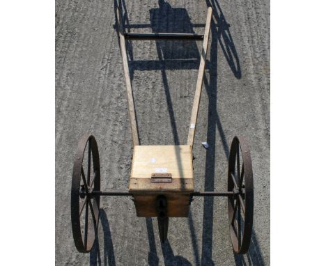 A seed drill. Constructed of wood with a metal frame and wooden handles, L150cm All items in this auction are sold as seen, W