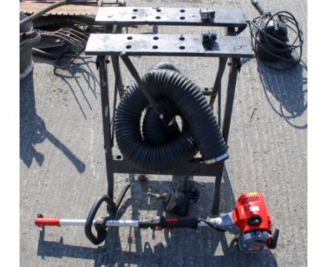 A group of four assorted items. Consisting of a Mitox 25C multi tool petrol engine, leaf blower hose, bench vice and workmate