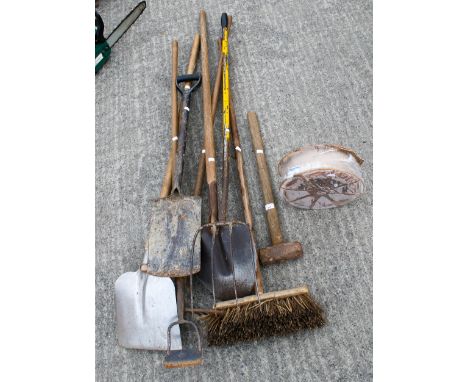 An assortment of gardening tools. Including a broom, pitchfork, spades, etc. All items in this auction are sold as seen, We a