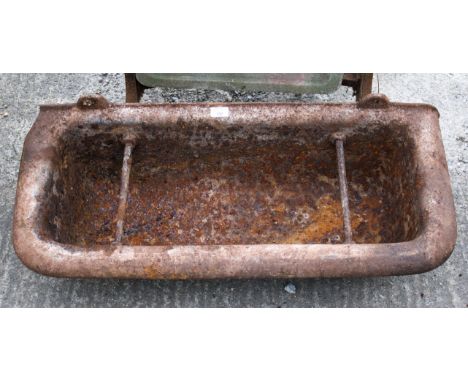 A cast metal pig trough. H29cm x W91cm x D39.5cmAll items in this auction are sold as seen, We are unable to provide conditio