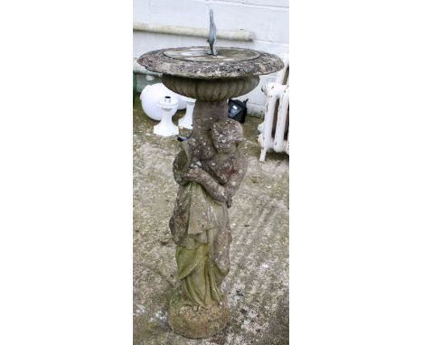 A two part sundial. The post in the form of a standing lady with draped robes, height circa 100cm. All items in this auction 
