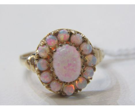 9ct YELLOW GOLD OPAL CLUSTER STYLE RING, large principal oval cut surrounded by circular cabochon cut, size O 