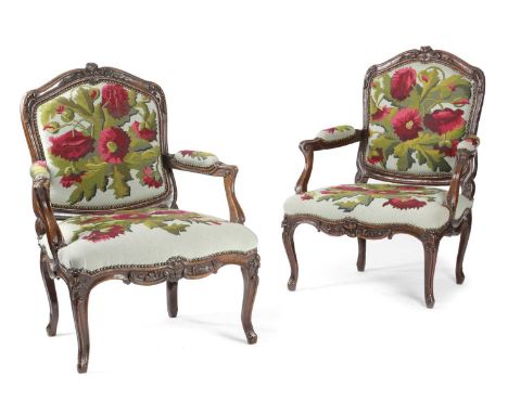 A PAIR OF FRENCH LOUIS XV WALNUT FAUTEUIL18TH CENTURYeach with a cartouche shaped back, the moulded frames carved with leaves