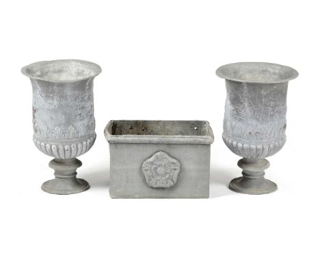 A PAIR OF LEAD GARDEN URNS PROBABLY 19TH CENTURYof campana shape with stiff leaf and lobed decoration, together with a rectan