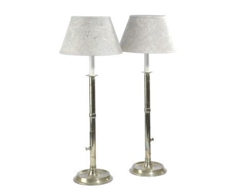 A PAIR OF BRASS EJECTOR CANDLESTICK TABLE LAMPS19TH CENTURYwith banded decoration and dished feet, fitted for electricity, wi