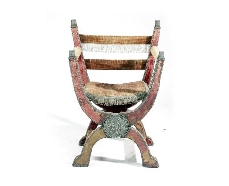 AN OAK FOLDING 'X' FRAME CHAIRIN TUDOR STYLE, 19TH CENTURYthe frame upholstered in red fabric edged with studs, the cushion w