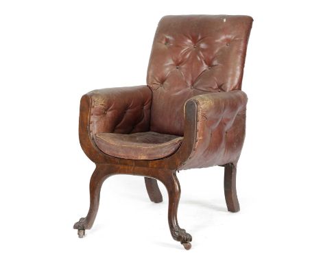 A VICTORIAN MAHOGANY LIBRARY ARMCHAIRMID-19TH CENTURYof lyre shape, button upholstered with maroon leather, on carved paw fee