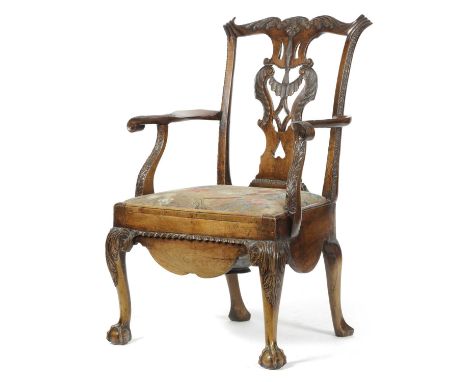 A GEORGE II RED WALNUT COMMODE OPEN ARMCHAIRIRISH, C.1750-60with a pierced and carved splat back decorated with frills and a 