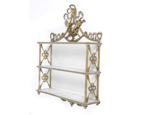 A SET OF GILTWOOD AND PAINTED WALL SHELVESEARLY 19TH CENTURYthe ribbon swag surmount above a floral wreath and trophies, with