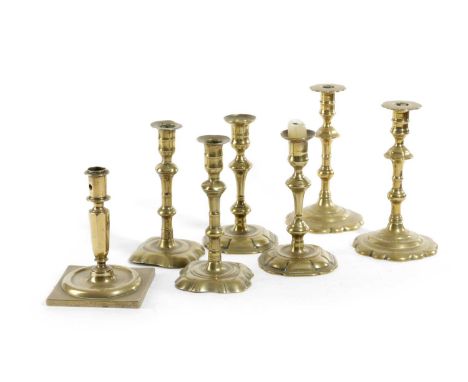 A PAIR OF BRASS CANDLESTICKSEARLY 18TH CENTURYeach with a foliate nozzle, above a knopped stem and a foliate foot, together w