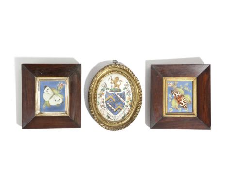 A PAINTED AND GILT COAT OF ARMS19TH CENTURYthe quatered arms beneath a lion rampant crest, together with a pair of ceramic pl