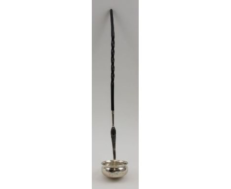 An 18th century silver toddy ladle, the bowl inset a George II sixpence, bright cut decoration to the stem as it meets the tw