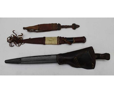 A Sanderson of Sheffield double edged bayonet with scabbard, together with two ethnic tourist knives