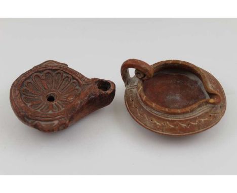 Two terracotta items of Ancient Roman form, comprising an oil lamp and a small jug, the lamp is 8cm x 7cm