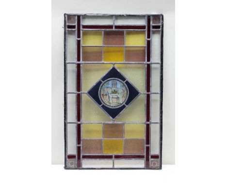 A first quarter 20th century multi-coloured leaded glass panel, with elephant and castle central motif, housed with a glazed 