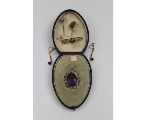 A 15ct gold brooch inset amethyst coloured stone, a pair of drop earrings, pendant with a seed pearl frame, and four stick pi