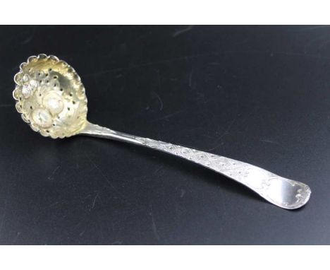 A George III silver berry embossed, sugar sifting ladle, gilded internal bowl, London 1800, 41g