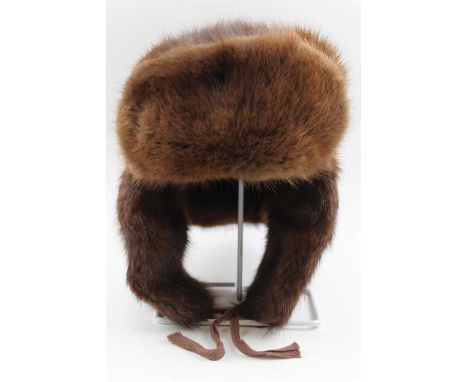 A fur hat with ear flaps, bears label "Pot Poht"