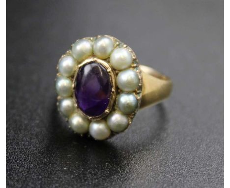 An 18ct gold ring, inset central amethyst cabochon, surrounded by eleven pearls, ring size; "P" gross weight: 7.8g