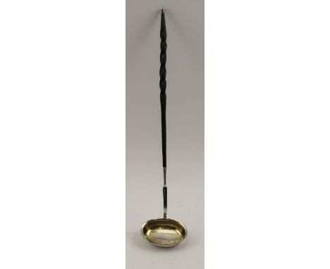A George III silver toddy ladle, with gilded interior, having twisted whale bone handle, London 1818