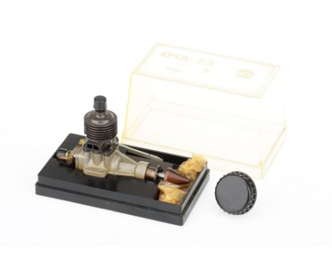 A USSR Model Diesel Internal Combustion Engine mounted in a plastic case with a clear acylic cover marked KMA-25 with a "star