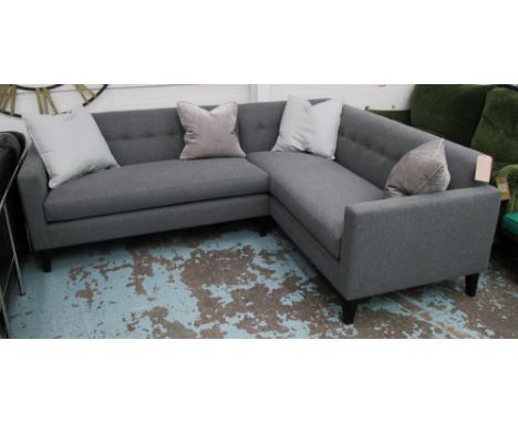 CORNER SOFA, in grey fabric buttoned back on square ebonised supports, 227cm x 187cm. 