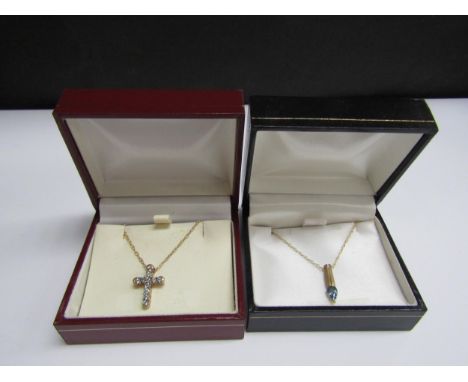 A 9ct gold blue stone set cross pendant hung on chain stamped 375, 45cm long and a 9ct gold blue topaz pendant hung on chain 