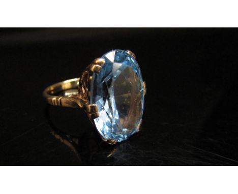 A gold ring set with a large oval blue stone, stamped 9ct. Size K, 5.6g 