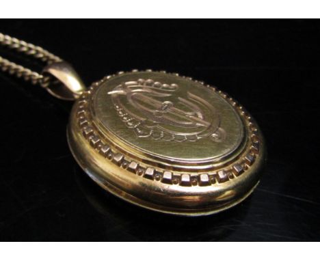 An 9ct gold chain, 62cm long, 11.6g with an unmarked gold Victorian oval locket, 11.1g (22.7g total)