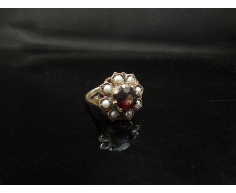 A 9ct gold garnet and pearl cluster ring. Size K, 3.9g 