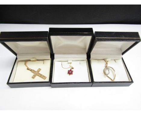 A ruby and diamond floral pendant hung on gold chain stamped 375, 46cm long, 9ct gold cross pendant on chain stamped 375, 46c