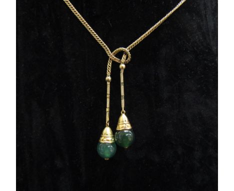 A gold chain stamped 585 hung with two jade drops, 40cm long, 7.3g 