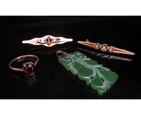 A gold brooch stamped 9ct, carved jade pendant, gold ring stamped 9ct and a costume brooch 