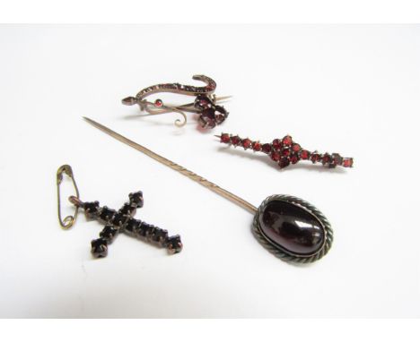 A cabochon garnet stick pin, two garnet bar brooches and a garnet cross pendant (4) 