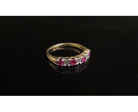 An unmarked gold ruby and diamond half hoop ring. Size N/O, 1.9g 