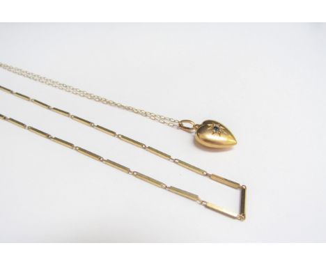 A heart shaped gold pendant with old cut diamond chips and sapphire stamped 15ct hung on a gold chain and a 9ct gold necklace