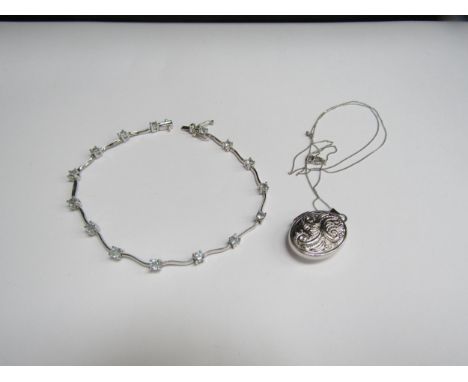 A 9ct white gold bracelet set with blue topaz and wavy links, 19cm long and a 9ct white gold engraved locket hung on chain st