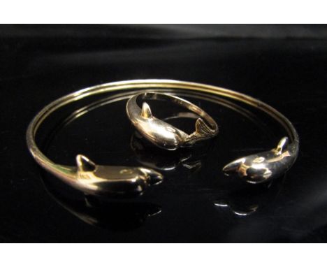 A gold bangle with dolphin terminals and a matching ring, stamped 585. Size Q, 6.7g 